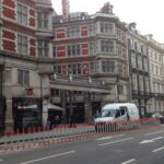 Orange and white on-highway pole cones providing lane separation on a city street