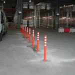 Off-highway pole cones temporarily installed inside a warehouse for demonstration purposes.