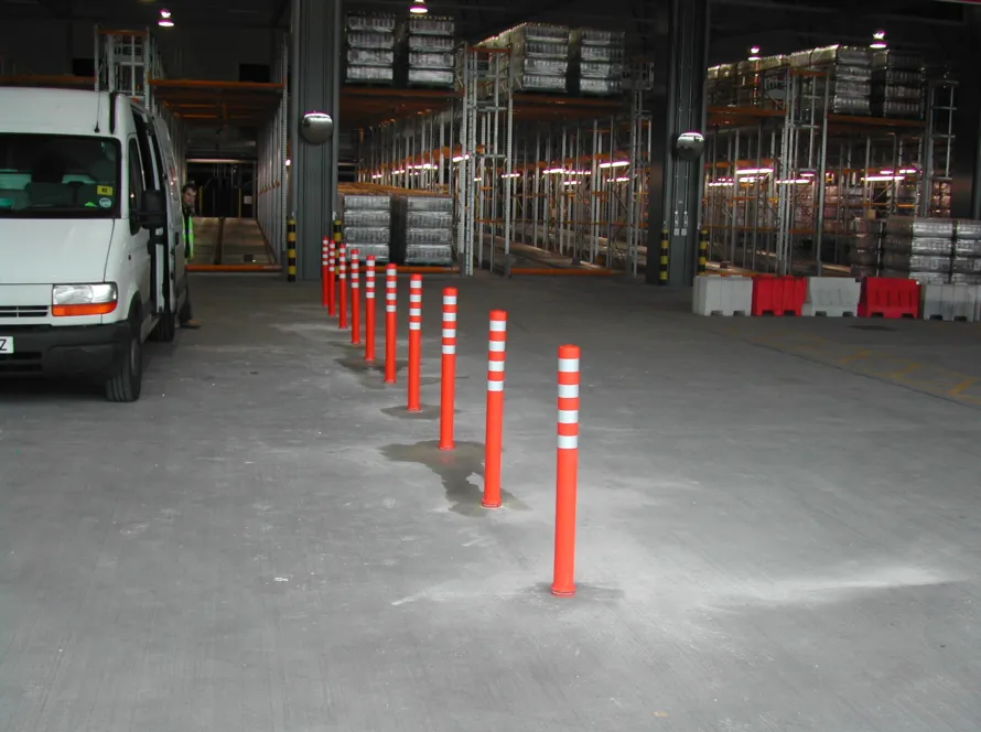 Off-highway pole cones temporarily installed inside a warehouse for demonstration purposes.