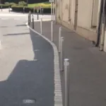 Stainless steel pole cones installed along a footway to separate pedestrians from vehicle traffic