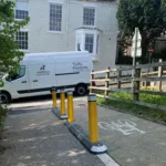 Milestone kerb unit with yellow reflective bollards separating pedestrian and cycle routes