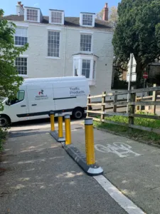 Milestone kerb unit with yellow reflective bollards separating pedestrian and cycle routes