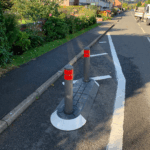 Satellite island featuring bollards to separate traffic near a residential footway