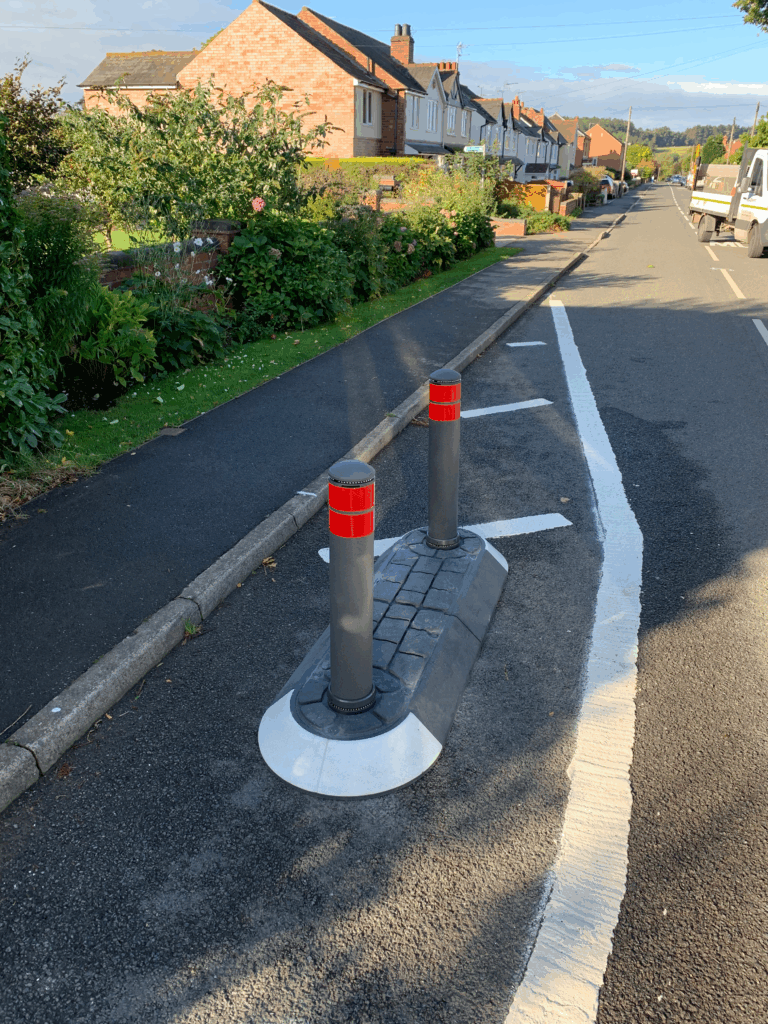 Satellite island featuring bollards to separate traffic near a residential footway