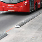 Milestone islands installed along the carriageway, featuring integrated glass dome road studs to improve visibility and delineate traffic lanes.