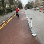 Milestone kerb unit with reflective bollards separating a cycle lane from traffic