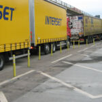 Off-highway yellow pole cones installed to prevent HGVs from parking along the edge of a service area
