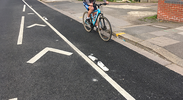 Mini Orca low-profile road separator installed to define a cycle lane alongside the main carriageway.