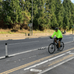 Cycle lane with a One Piece Wand Orca featuring flexible posts and Orca lane separators installed to provide light segregation between cyclists and traffic.