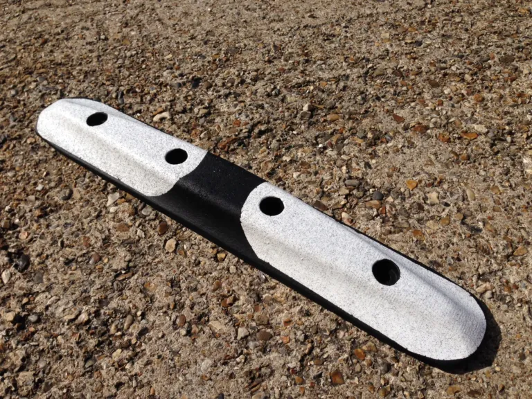 Mini Orca road separator with black and white reflective finish, designed for low-profile lane segregation.