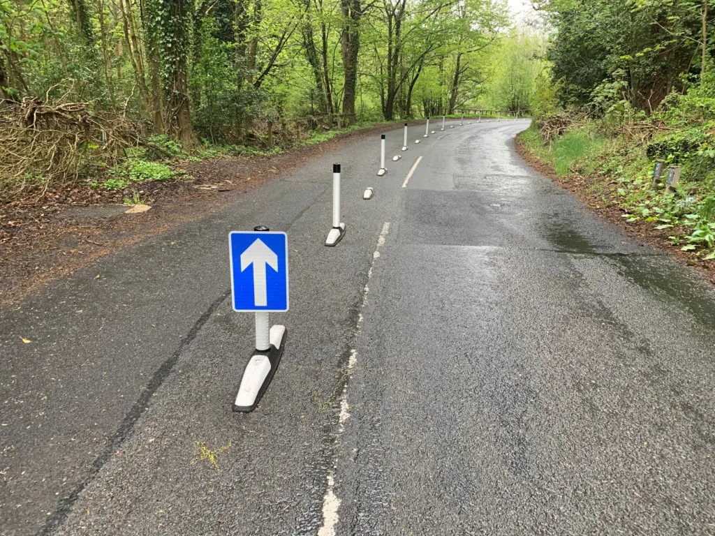 One-piece Wand Orca lane separators installed along a rural road, guiding traffic in a single direction.