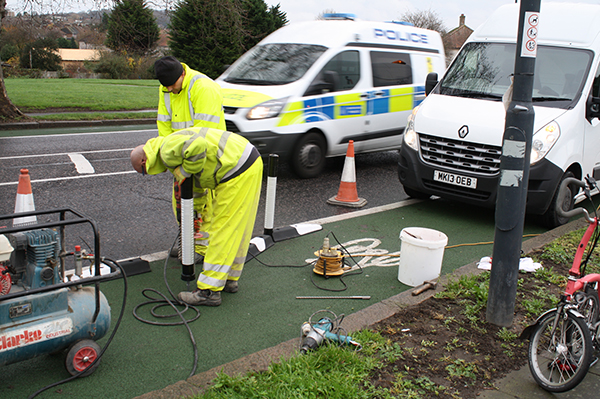 Installation of Greenwich Wand Orca rubber lane divider on a cycle lane, with bollards and traffic management in place.”