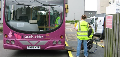 Bus ramp deployed from a bus during accessibility testing to provide step-free boarding for wheelchair users.