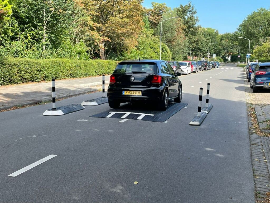 Rubber speed cushion installed on a residential street in the Netherlands, shown with satellite islands and milestone islands to create a traffic-calming road layout.