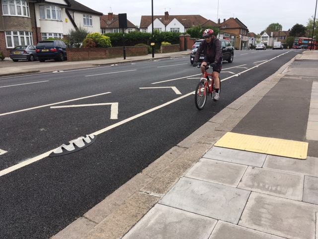 Orca cycle lane separator installed on an urban road, guiding cyclists with raised rubber segregation units.