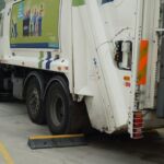 TruckStop 150 wheel stop positioned behind a lorry wheel to prevent vehicle movement.