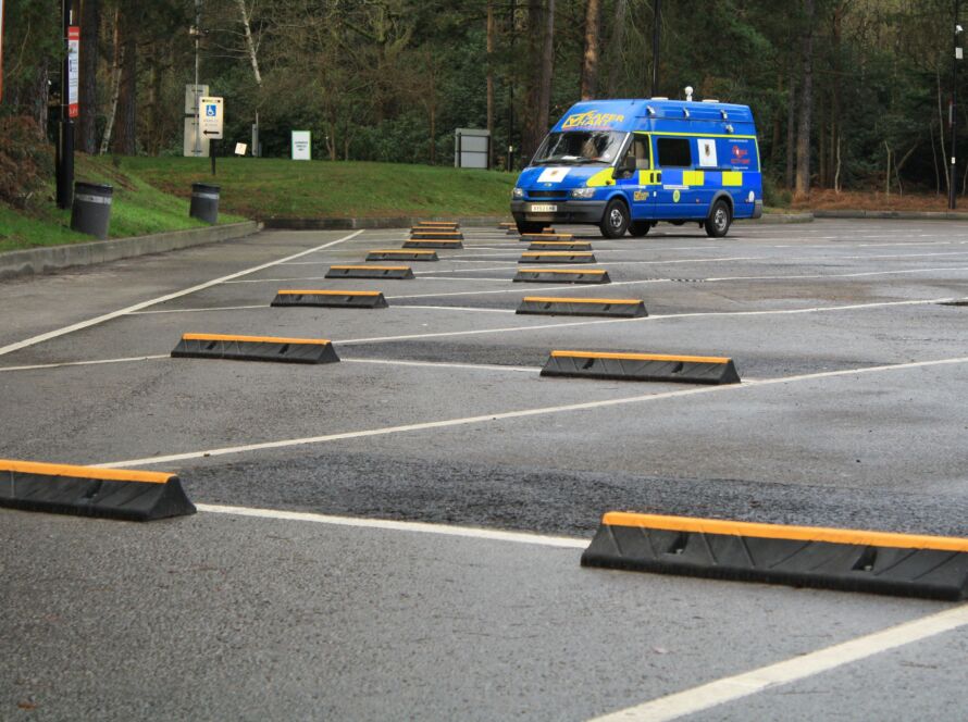 TruckStop 115 heavy-duty wheel stop with high-visibility yellow markings installed on a paved surface.