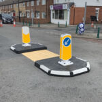 RediPave pedestrian traffic island with RediFix tactile paving and bollards on an urban street