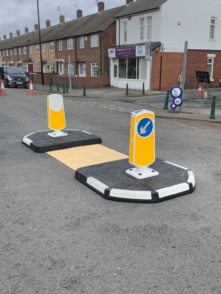 RediPave pedestrian traffic island with RediFix tactile paving and bollards on an urban street
