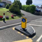 RediPave traffic island installed on a carriageway, featuring a modular island base with an integrated keep-left sign to guide vehicles.