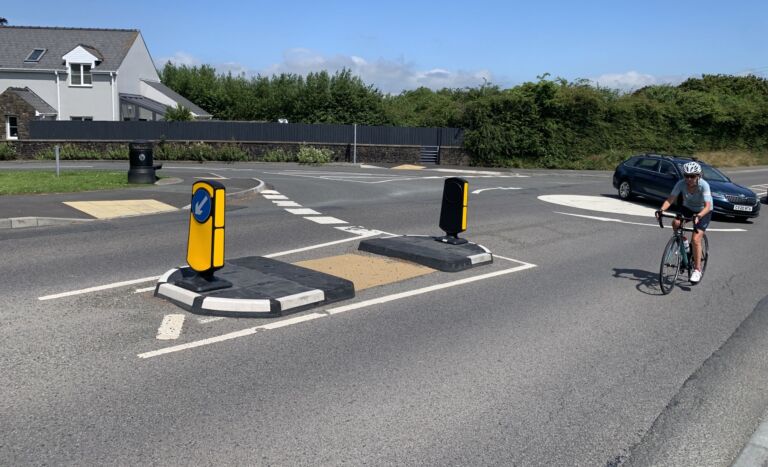 RediPave pedestrian traffic island with RediFix tactile paving and bollards on an urban street