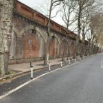 Black and white on-highway pole cones creating separation between a cycle lane and vehicle traffic