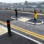 RediPave pedestrian traffic island with RediFix tactile paving and bollards on an urban street