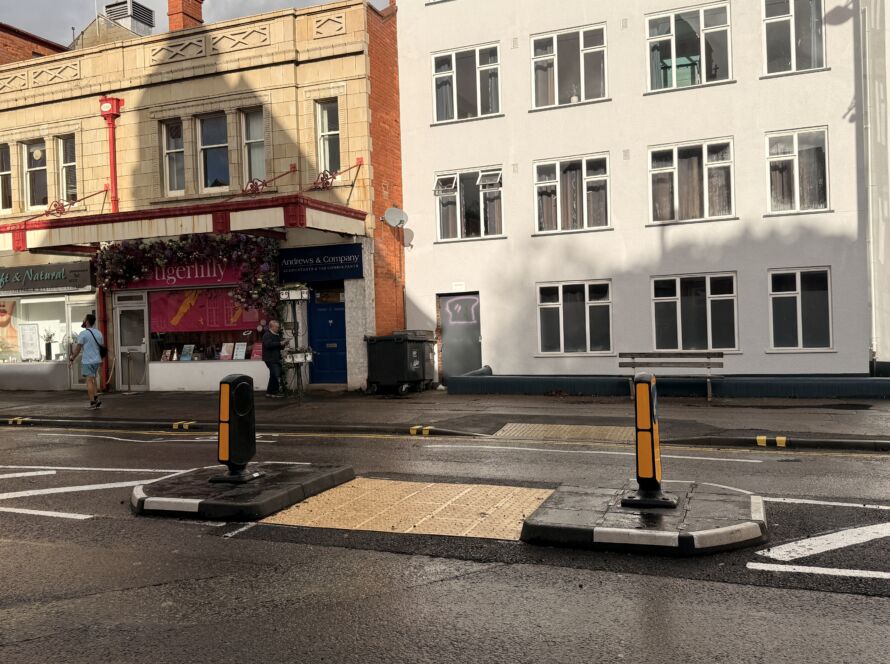RediPave pedestrian traffic island with RediFix tactile paving and bollards on an urban street