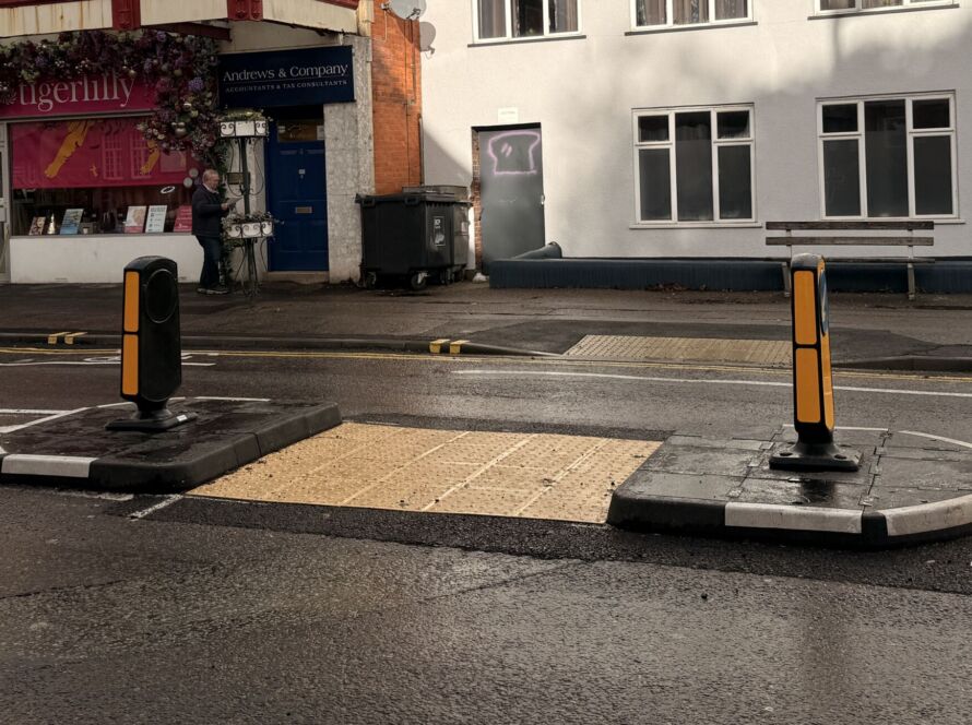 RediPave pedestrian traffic island with RediFix tactile paving and bollards on an urban street