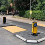 RediPave pedestrian traffic island with RediFix tactile paving and bollards on an urban street