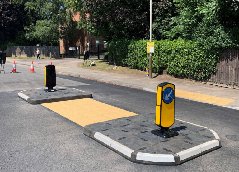 RediPave pedestrian traffic island with RediFix tactile paving and bollards on an urban street