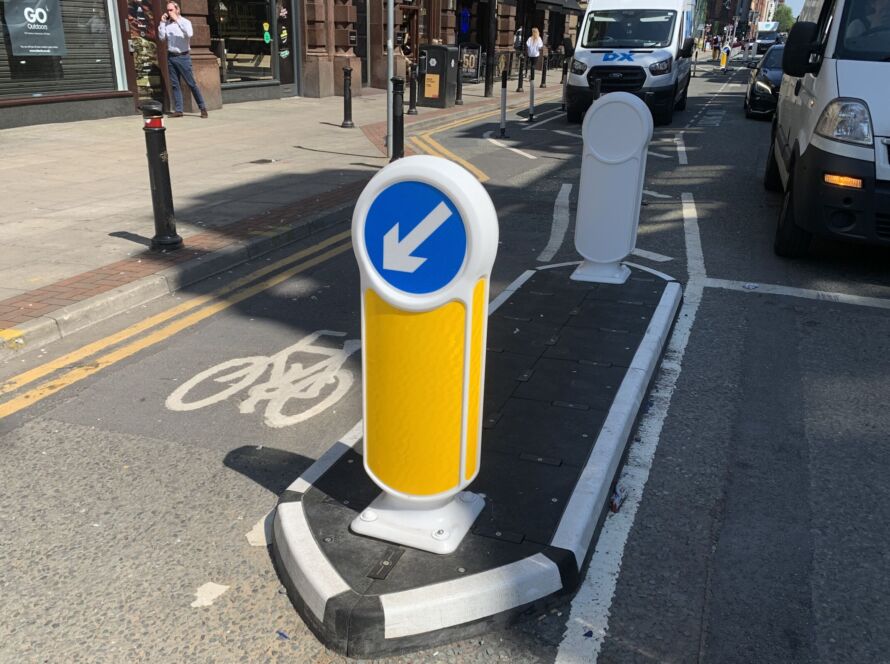 RediPave traffic island with keep-left bollard separating a cycle lane from traffic on an urban street.