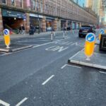 RediPave traffic islands with keep-left bollards and on-highway pole cones creating lane separation on an urban street.