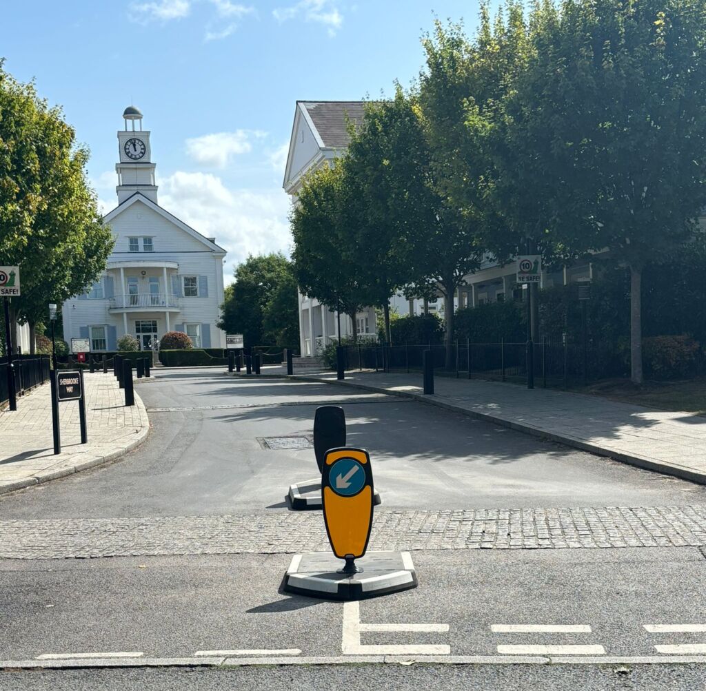 RediPave modular traffic island with keep-left bollard forming a pedestrian refuge on a residential street.
