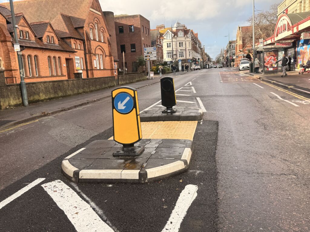 RediPave pedestrian traffic island with RediFix tactile paving and bollards on an urban street