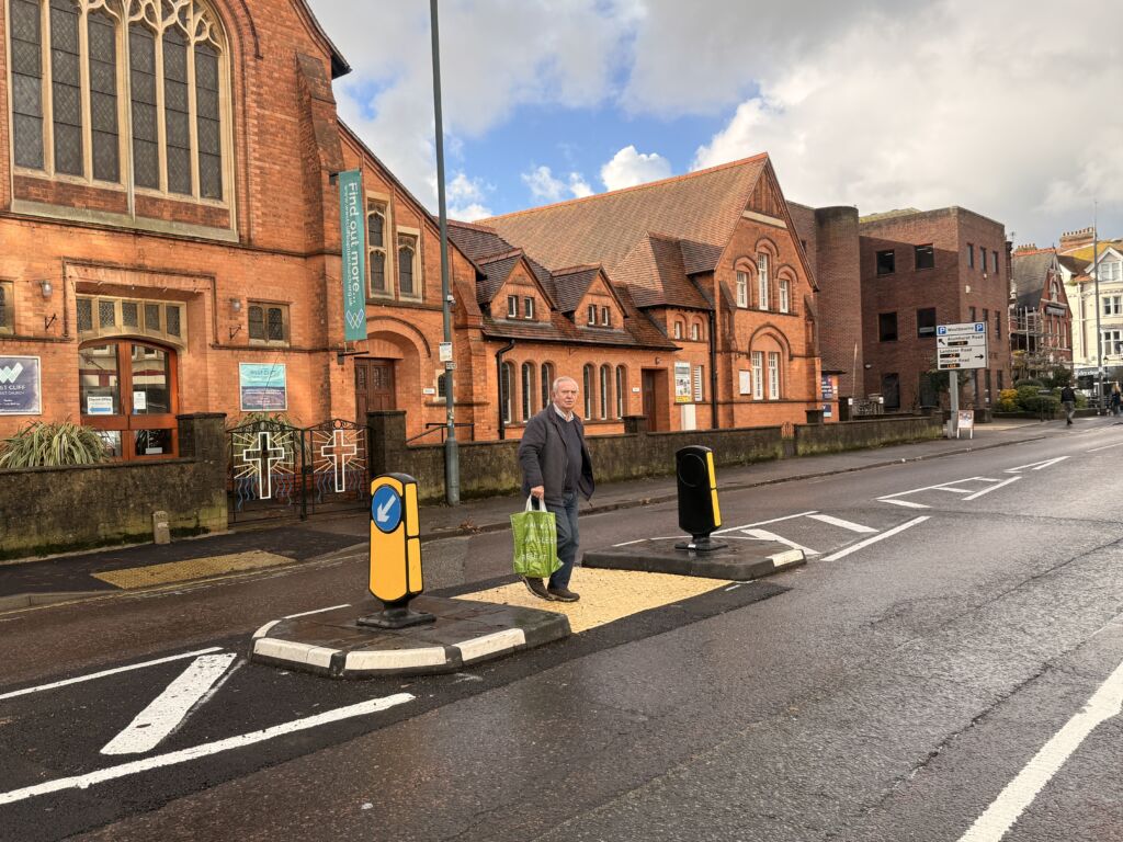 RediPave pedestrian traffic island with RediFix tactile paving and bollards on an urban street