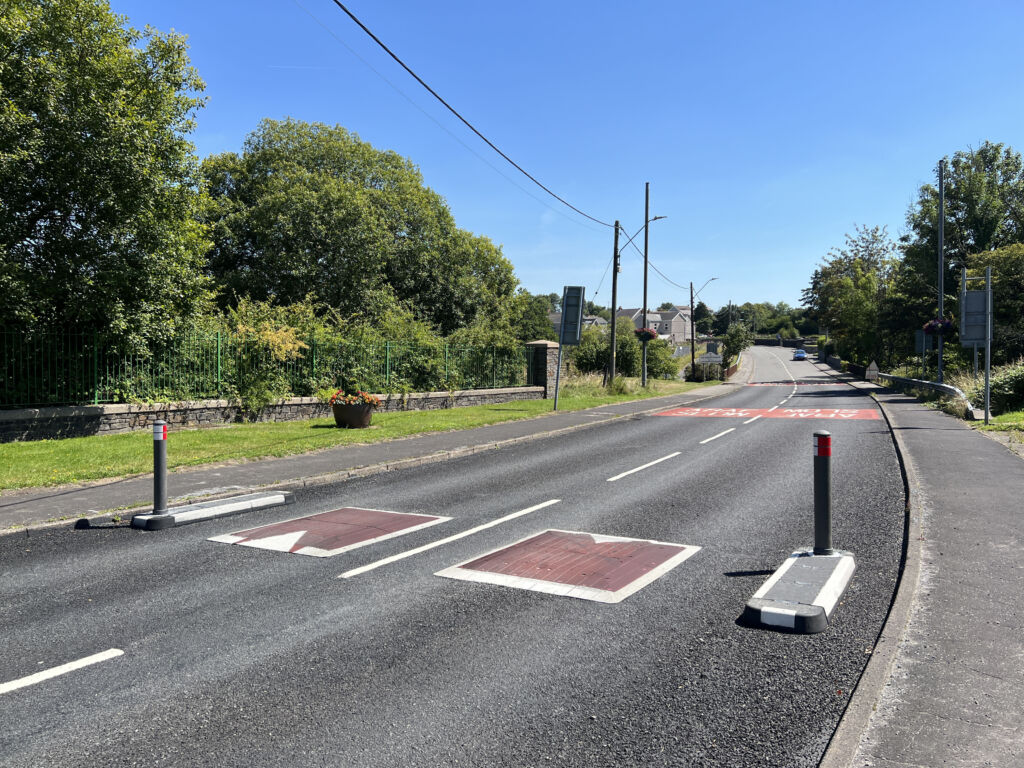 RediPave 500 mm splitter islands installed alongside Traficop speed cushions on a two-lane road, used to calm traffic and guide vehicle movement.