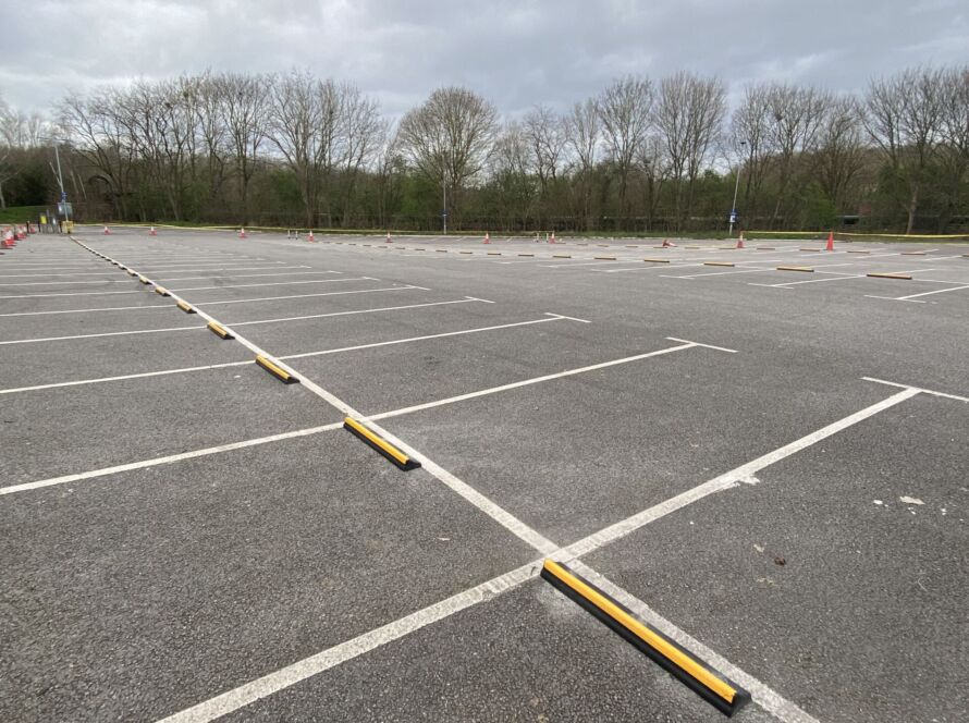 CarStop wheel stops with yellow reflective strip installed in a car park to define parking bays.
