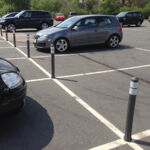 City pole cones installed between parking bays to prevent vehicle overrun and define parking spaces