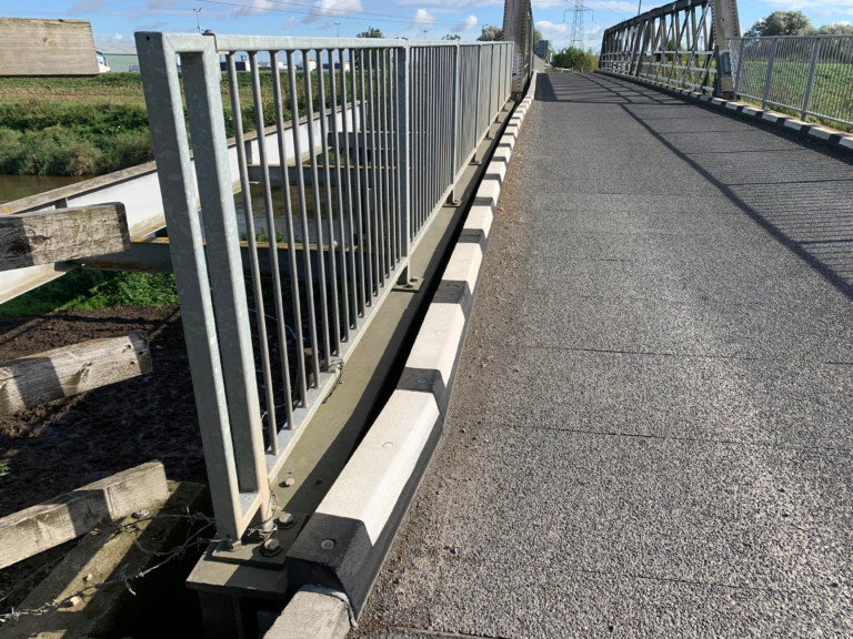 Harlow Kerb installed along the edge of a bridge walkway
