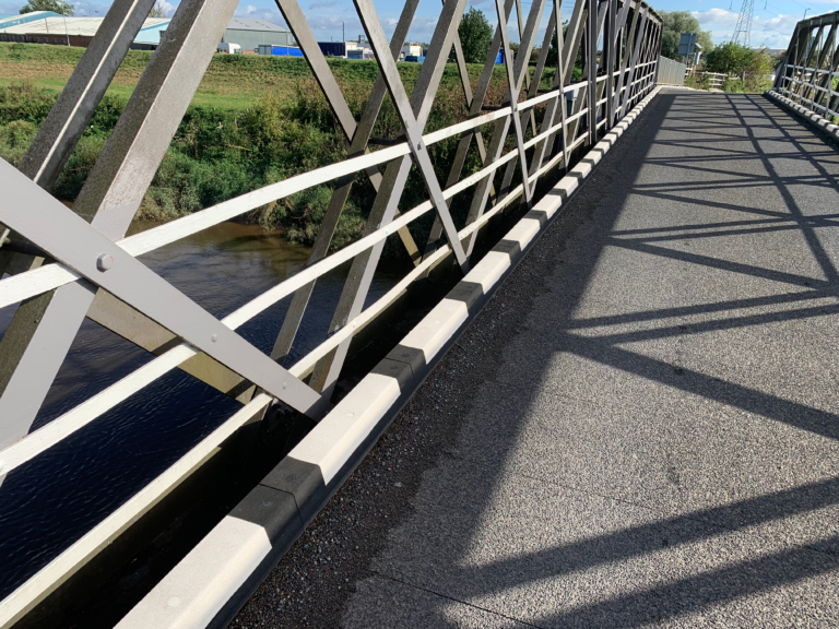 Harlow Kerb installed along the edge of a bridge walkway
