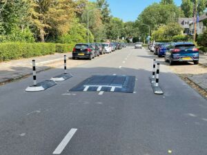 Rubber speed cushion installed on a residential street in the Netherlands, shown with satellite islands and milestone islands to create a traffic-calming road layout.