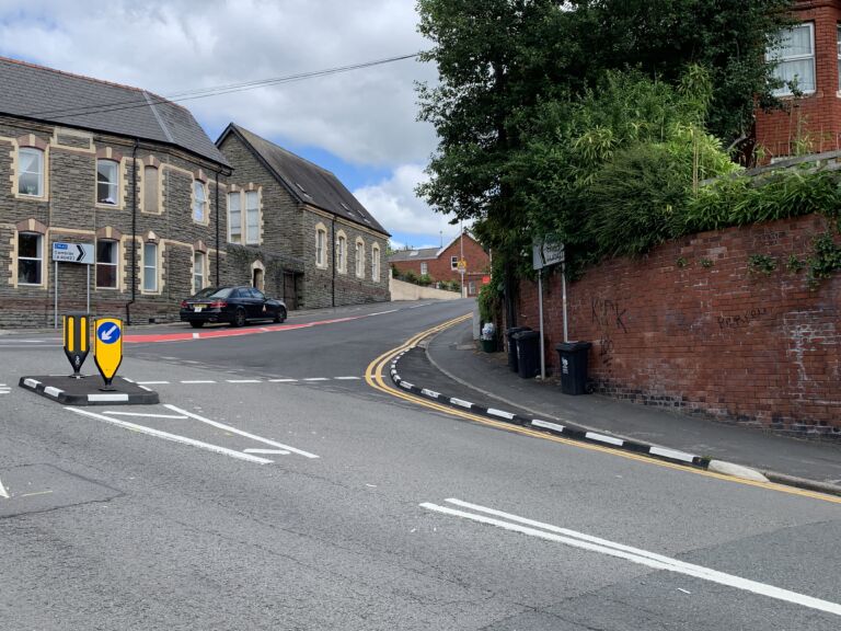 Half Battered (HB) RediKerb kerbing forming a raised traffic island with bollards at a road junction
