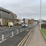 Milestone kerb unit with reflective bollards separating a cycle lane from traffic