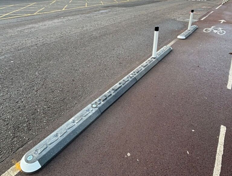Milestone island system with reflective bollards and glass light domes separating a cycle lane from the carriageway