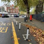 Black and white on-highway pole cones installed to guide traffic along a roadside