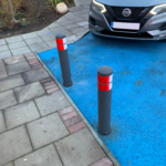 City pole cones installed at the edge of a marked parking bay to prevent vehicle overrun