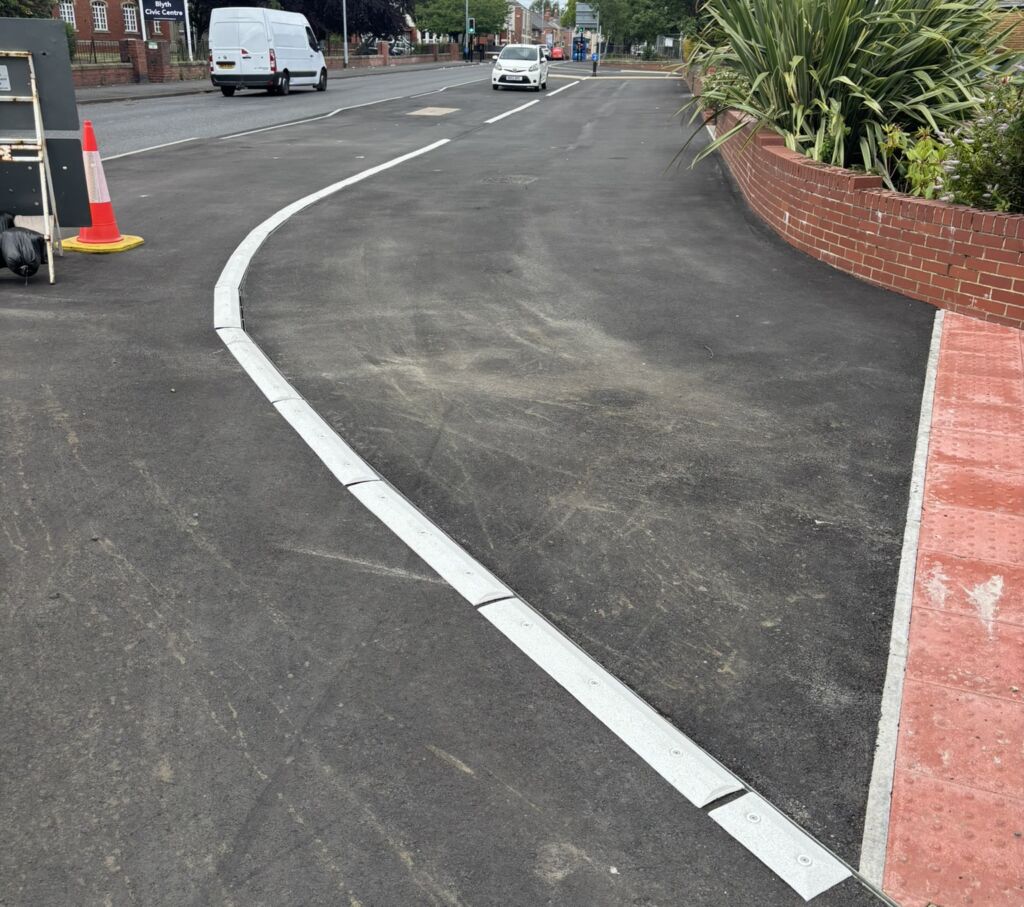 Raised line delineator installed on a shared-use path to separate pedestrians and cyclists.