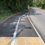 Raised line delineator installed alongside a segregated cycle lane to define the cycling route.