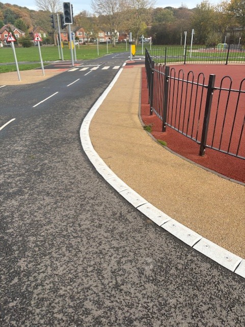 Raised line delineator installed alongside a segregated cycle lane to define the cycling route.